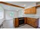 Kitchen with wooden cabinets, stainless steel appliances and an open concept to the eat-in area at 3518 Woodale Rd, Indianapolis, IN 46234
