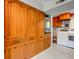 Convenient laundry area with wood cabinets and side-by-side washer and dryer at 3518 Woodale Rd, Indianapolis, IN 46234