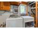 Practical laundry area featuring a side-by-side washer and dryer, and a window for natural light at 3518 Woodale Rd, Indianapolis, IN 46234