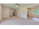 A view of the living room with a ceiling fan and staircase from the adjacent room at 3518 Woodale Rd, Indianapolis, IN 46234