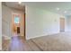 Bright living room with new carpet, a view to the bath, and fresh paint at 3518 Woodale Rd, Indianapolis, IN 46234