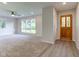 Bright living room with new carpet, a ceiling fan, and large windows at 3518 Woodale Rd, Indianapolis, IN 46234