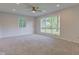 Bright living room with new carpet, a ceiling fan, and large windows at 3518 Woodale Rd, Indianapolis, IN 46234