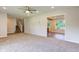 Spacious living room open to the staircase, with carpet flooring and a view into the adjacent room at 3518 Woodale Rd, Indianapolis, IN 46234