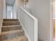 Stairway with carpeted steps and white painted walls and banister at 3518 Woodale Rd, Indianapolis, IN 46234