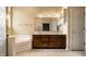 Well lit bathroom features a double sink vanity, soaking tub, and a tile floor at 3556 Towne Dr, Carmel, IN 46032