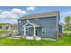 Backyard with a covered patio, outdoor seating, fire pit, and meticulously maintained lawn at 3650 Merchmont Rd, Bargersville, IN 46106