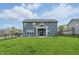 A large fenced backyard with a covered patio, and green lawn, perfect for outdoor activities at 3650 Merchmont Rd, Bargersville, IN 46106