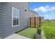 Side yard view features modern privacy screen, artificial grass, and view of exterior siding at 3650 Merchmont Rd, Bargersville, IN 46106