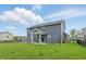 Spacious fenced backyard with a covered patio and manicured lawn at 3650 Merchmont Rd, Bargersville, IN 46106