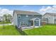 Backyard view featuring a covered patio, outdoor seating, and well-manicured lawn at 3650 Merchmont Rd, Bargersville, IN 46106