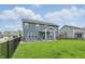 Large fenced backyard featuring a covered patio, outdoor seating, and lush green lawn at 3650 Merchmont Rd, Bargersville, IN 46106