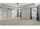 Airy bedroom showcases tray ceilings, a sliding barn door, and large windows with backyard views at 3650 Merchmont Rd, Bargersville, IN 46106