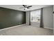 Bright bedroom features a ceiling fan, large window, neutral walls, and plush carpeting at 3650 Merchmont Rd, Bargersville, IN 46106