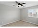 Neutral bedroom with fan, plush carpet, and large window offering plenty of natural light at 3650 Merchmont Rd, Bargersville, IN 46106