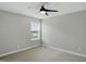 This bright bedroom features a ceiling fan, plush carpet, and a window for natural light at 3650 Merchmont Rd, Bargersville, IN 46106