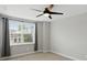 Bedroom showcases a large window with neighborhood views, complemented by a modern ceiling fan at 3650 Merchmont Rd, Bargersville, IN 46106