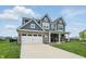 Beautiful blue two-story home featuring a spacious driveway, attached garage, and lush green lawn at 3650 Merchmont Rd, Bargersville, IN 46106