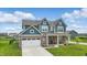 Two-story blue home with a brick facade, attached garage, and a neatly landscaped front yard at 3650 Merchmont Rd, Bargersville, IN 46106