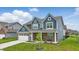 Inviting two-story home featuring blue siding, a brick foundation, and a well-kept lawn at 3650 Merchmont Rd, Bargersville, IN 46106