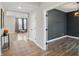 Spacious hallway featuring wood floors, neutral walls, and access to multiple rooms at 3650 Merchmont Rd, Bargersville, IN 46106