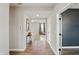 Hallway with wood floors leads to a living area with neutral walls and elegant decor at 3650 Merchmont Rd, Bargersville, IN 46106