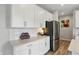 Modern kitchen with white cabinets, stainless steel refrigerator and stylish decor at 3650 Merchmont Rd, Bargersville, IN 46106