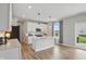 Modern kitchen featuring white cabinets, a center island, and sliding glass door access to the backyard at 3650 Merchmont Rd, Bargersville, IN 46106