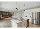 Modern kitchen with stainless steel appliances, island, and open floor plan at 3650 Merchmont Rd, Bargersville, IN 46106