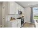 Bright kitchen with stainless steel oven, microwave and shaker cabinets at 3650 Merchmont Rd, Bargersville, IN 46106