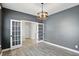 Modern office space with gray walls, hardwood floors, and a stylish light fixture at 3650 Merchmont Rd, Bargersville, IN 46106