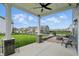 Covered patio with a fire pit, seating, and a view of the landscaped backyard at 3650 Merchmont Rd, Bargersville, IN 46106