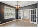 Gray room with wood floors, modern lighting, and french doors offers a stylish and versatile space at 3650 Merchmont Rd, Bargersville, IN 46106