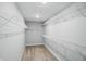 Walk-in closet with ample shelving and neutral carpeting is ready for organizing your wardrobe at 3650 Merchmont Rd, Bargersville, IN 46106