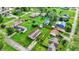 An aerial view of a quaint neighborhood featuring well-maintained homes, green lawns, and mature trees on a sunny day at 405 N Church St, Mooresville, IN 46158