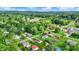 Aerial view of a charming, verdant neighborhood with well-kept homes nestled among mature trees and blue skies at 405 N Church St, Mooresville, IN 46158
