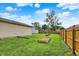 Large, fenced backyard with a storage shed, fire pit, and multiple garden beds at 405 N Church St, Mooresville, IN 46158