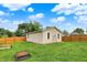 The property boasts a large, green backyard, complete with wooden fencing and multiple garden beds at 405 N Church St, Mooresville, IN 46158