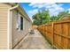 View of the home's backyard from the side featuring siding and a wooden fence at 405 N Church St, Mooresville, IN 46158