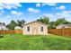 A well-maintained lawn with a wooden fence and raised garden beds defines this home's backyard at 405 N Church St, Mooresville, IN 46158