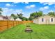 Spacious backyard with lush green grass, wooden fence, and garden beds, ideal for gardening and relaxation at 405 N Church St, Mooresville, IN 46158