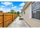 A view of the home's backyard from the side, featuring a concrete path and a wooden fence at 405 N Church St, Mooresville, IN 46158