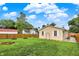 Spacious backyard with green grass, a wooden fence, and the back of the home at 405 N Church St, Mooresville, IN 46158