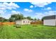 Large backyard featuring a fire pit and storage shed, perfect for outdoor activities and storage at 405 N Church St, Mooresville, IN 46158