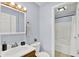 Bright bathroom with neutral walls, a mirror and a toilet and a shower at 405 N Church St, Mooresville, IN 46158