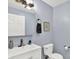 Bathroom featuring a white sink vanity, a framed picture, a towel ring, and a toilet at 405 N Church St, Mooresville, IN 46158