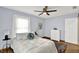 Bright bedroom with neutral walls, a large window, and a comfortable queen-sized bed at 405 N Church St, Mooresville, IN 46158