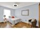 Bright bedroom with neutral walls, a big window and a sofa chair at 405 N Church St, Mooresville, IN 46158