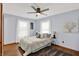 Cozy bedroom features a ceiling fan, beautiful windows, and a comfortable queen-sized bed at 405 N Church St, Mooresville, IN 46158