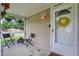 Covered front porch with outdoor seating featuring a view of the quiet neighborhood at 405 N Church St, Mooresville, IN 46158